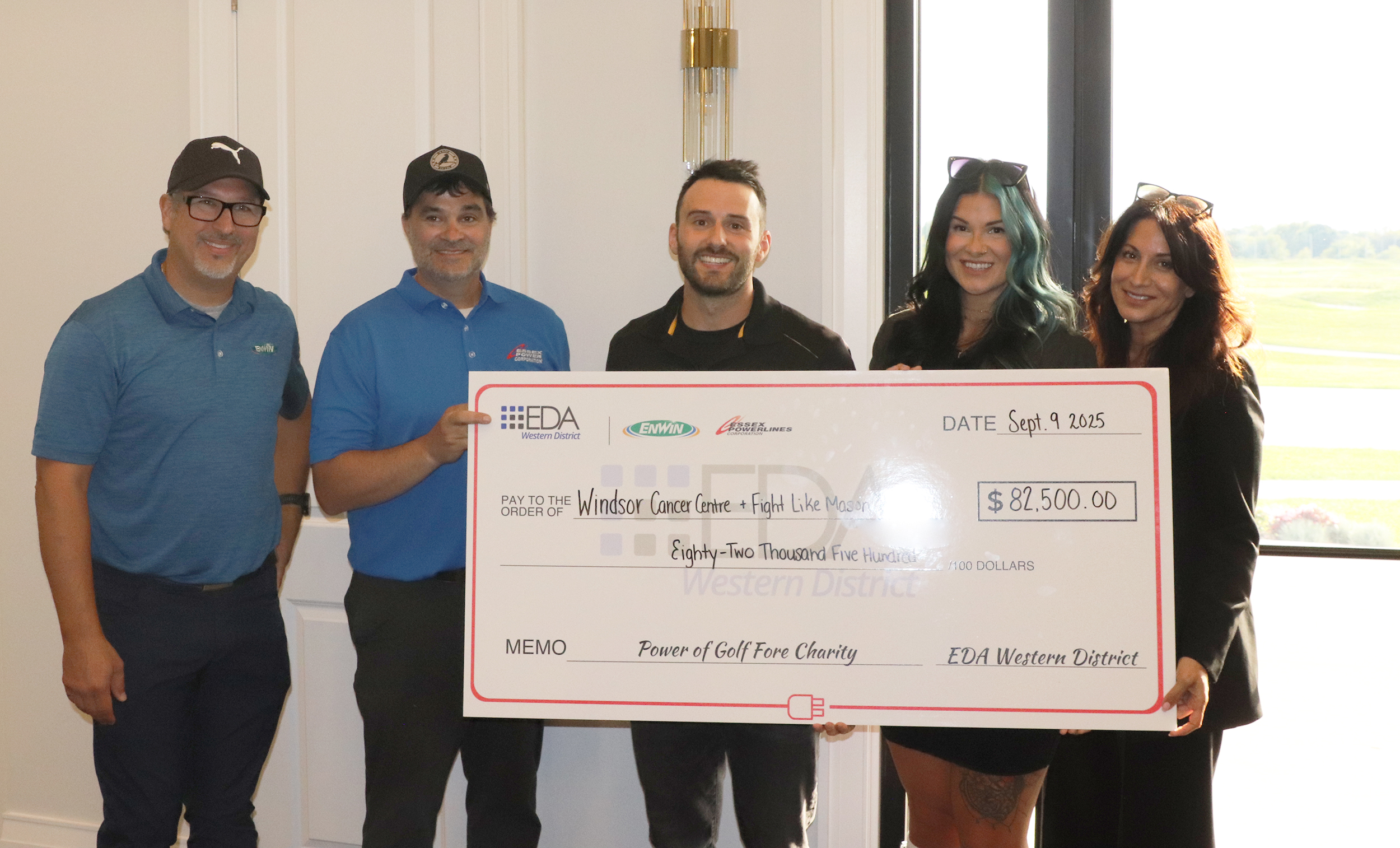 A group of people holding a giant check