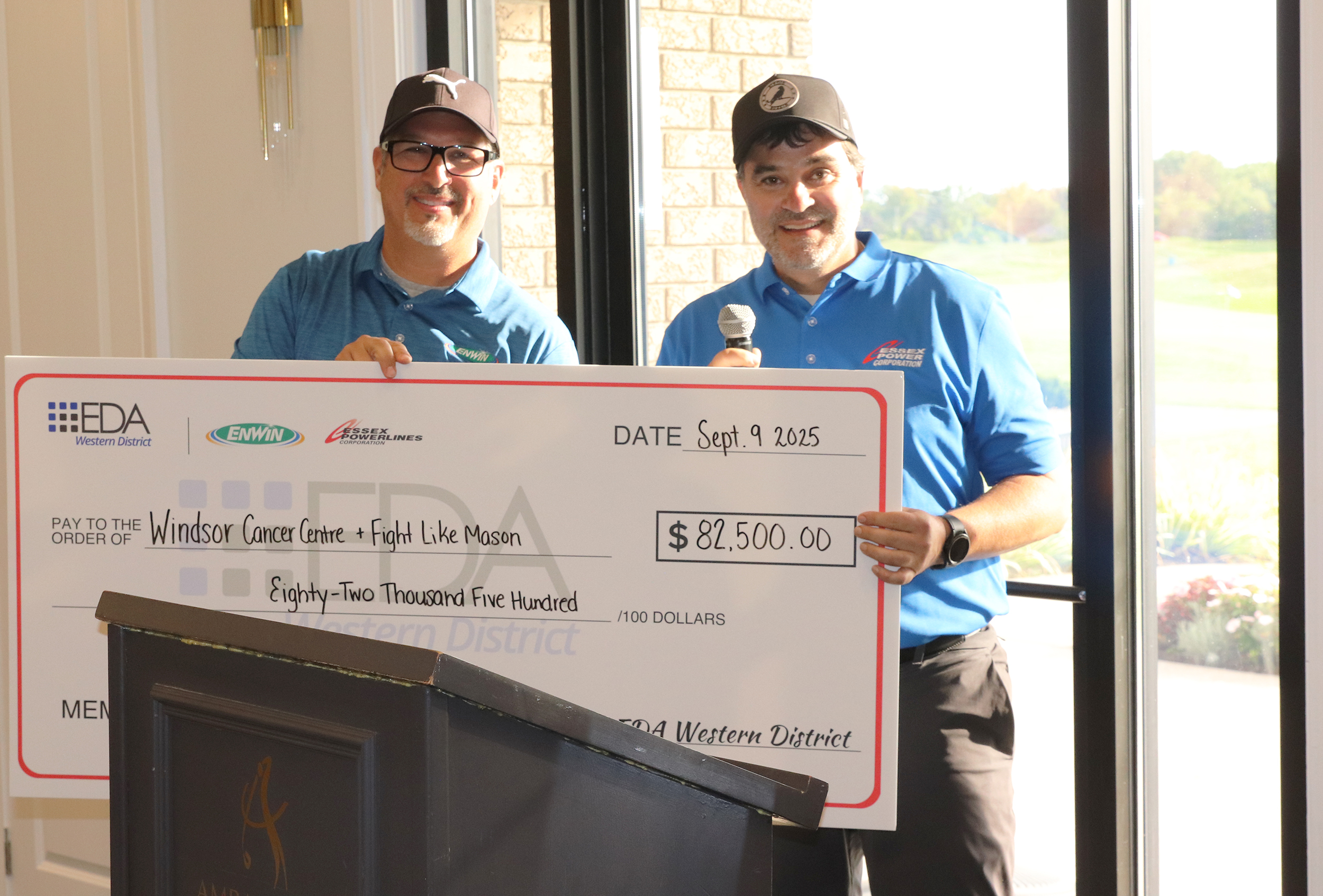 two people holding a check